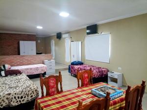 a room with two beds and a projection screen at Atardecer serrano in Mina Clavero