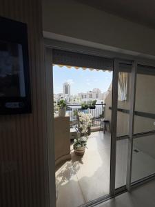 a balcony with a view of a city at Mykonos unite in Rishon LeẔiyyon