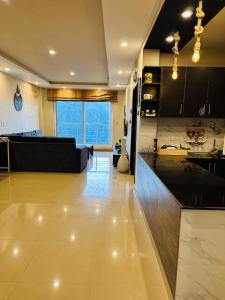 a large living room with a couch and a kitchen at Apartment In Ayubia in Naka +8 photos