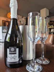a bottle of wine and two glasses on a table at The King's Head, Lanchester in Durham +17 photos