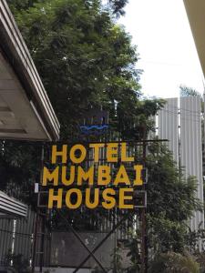 a sign for a hotel muharram house at Hotel Mumbai House Thane in Thane