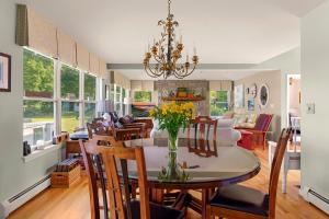 a dining room and living room with a table and chairs at Waterfront Estate w Hot Tub, Dock & Kayaks in Stonington