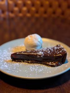 a piece of chocolate dessert with a scoop of ice cream at The King's Head, Lanchester in Durham