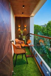 a balcony with two chairs and a table and a window at The jaish heaven in Rushikonda