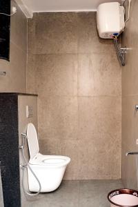a bathroom with a white toilet in a room at The jaish heaven in Rushikonda +5 photos