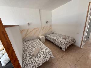 a room with two beds in a room at Marlenghi Apartments 818 in San Bartolomé +3 photos