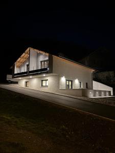 a house with lights on the side of it at night at Les Loges de Sainte Anne in Saint-Michel-de-Maurienne