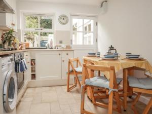 a kitchen with a table and chairs and a sink at 15 Boscaswell Downs in Penzance