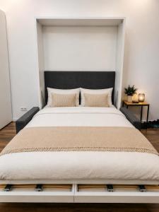 a bedroom with a large bed with a black headboard at Jagdhof Apartments am Spitzingsee in Schliersee