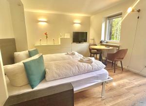 a bedroom with a bed and a table with chairs at Jagdhof Apartments am Spitzingsee in Schliersee