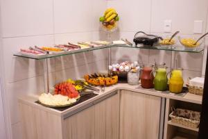 a buffet with a bunch of food and drinks at Pousada Casarão Schmidt in Pomerode