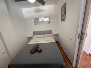 a small bedroom with a bed in a room at Marlenghi Apartments 412 in San Bartolomé +4 photos