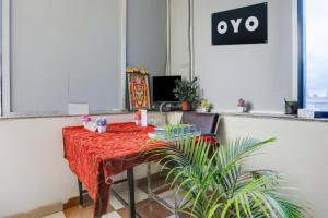 a table with a red table cloth on it in an office at Hotel O Aqua Comforts in Yelahanka