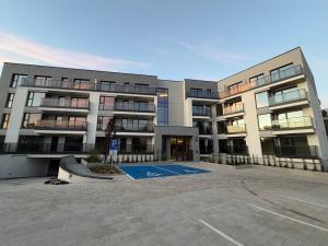 a large building with a basketball court in front of it at MC Residence Łomża in Łomża