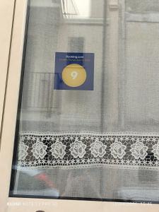 a window with a yellow frisbee on a curtain at Da zio Michele in Scilla +34 photos