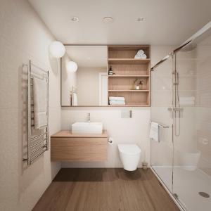 a bathroom with a sink and a toilet and a shower at Cormorant Rock Chalets in Ingonish Beach +12 photos