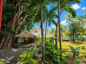 a house with palm trees in a park at Tropical Chic Studio - Marina View - Swimming Pool in Les Trois-Îlets