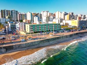 an aerial view of a city with a beach and buildings at Portobello Pituba Praia in Salvador +69 photos