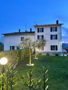 a large white building with a tree in the yard at B&B Codivilla in Sasso Marconi