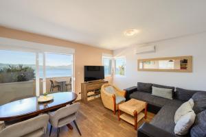 a living room with a couch and a table at Holiday Home in Komarna