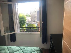 a window with a view of a city at Near Paris in Ris-Orangis