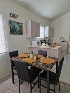 a kitchen with a table and chairs in a kitchen at Discovery Bay Villa and Beach Club in Discovery Bay