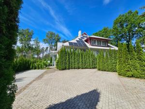 a house with solar panels on top of a driveway at Kapucino in Jūrmala