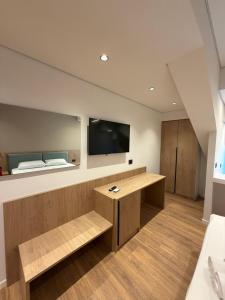 a room with a desk and a tv on the wall at The Factory Boutique in Vlorë +34 photos