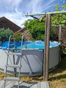 a boat and a chair next to a pool at Cabana Toxosoutos in Tojos Outos +18 photos