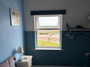 a window in a room with a green wall at Henry's On The Prom in Great Yarmouth +18 photos