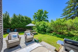 a patio with two chairs and a table at Cape Cod Cottage near Beaches & Downtown in Chatham