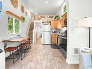a kitchen with a table and a refrigerator at Lake Sutherland Chalet Tiny home with lake access in Port Angeles