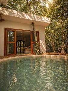 a swimming pool in front of a house at Selva Morena in Felipe Carrillo Puerto +15 photos