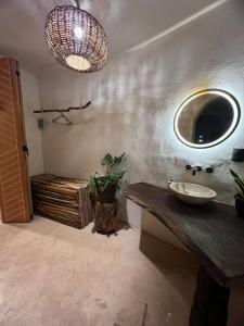 a bathroom with a sink and a mirror on the wall at Selva Morena in Felipe Carrillo Puerto