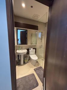 a bathroom with a toilet and a sink at Ocean View Corner Studio Private Balcony Tambuli Tower F in Maribago +8 photos
