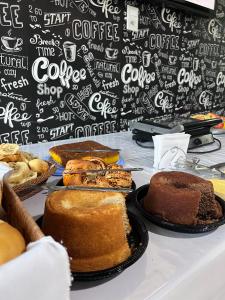 a table with different types of cakes on it at Hotel Via Center in Divino