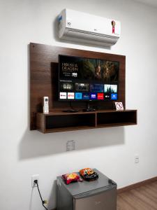 a flat screen tv hanging on a wall at Hotel Via Center in Divino