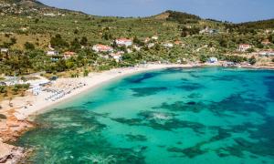 an aerial view of a beach with blue water at Studios Panagiotas House Astris in Astris