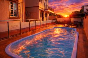 a hot tub on the balcony of a building with a sunset at Pousada Casarão Schmidt in Pomerode