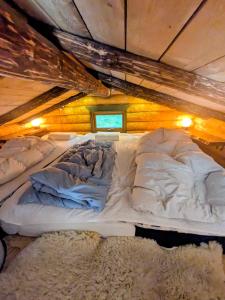 a large bed in a room with a ceiling at Cozy Lakeside Adventure - Biberburg am See in Osby +20 photos
