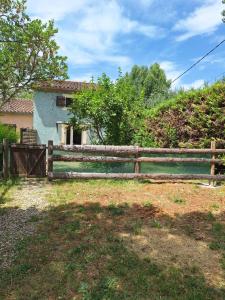 a wooden fence in front of a house at Les cyprès in Lagorce