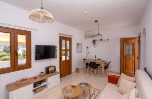 a living room with a couch and a table at Flo Guest House in Sifnos