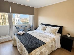a bedroom with a bed and a large window at Alto Arrayán II in Osorno