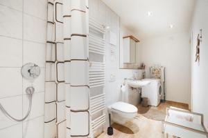 a white bathroom with a toilet and a sink at Landhof Riehlingshöhe in Kißlegg +12 photos