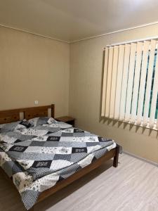 a bedroom with a bed with a quilt on it at Guest house at the Lake Sevan in Sevan