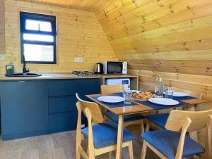 a wooden kitchen with a table and chairs in a room at Villetta Sioni in Sioni