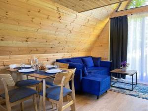 a living room with a blue couch and a table at Villetta Sioni in Sioni