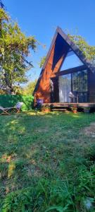 a small house on a field in the grass at Villetta Sioni in Sioni +2 photos