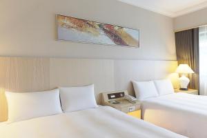 Voodi või voodid majutusasutuse Santos Hotel toas