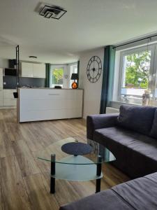 a living room with a couch and a glass table at Ferienwohnung Lolek in Brilon